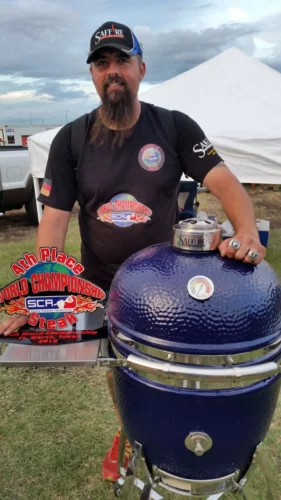 Daniel Raeder showing off his 2018 SCA World Championship trophy in front of a Large Platinum Saffire.