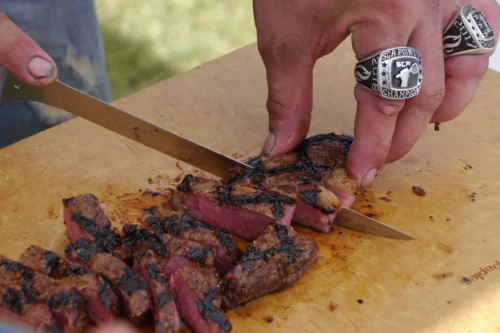 Daniel Raeder slicing up a steak.