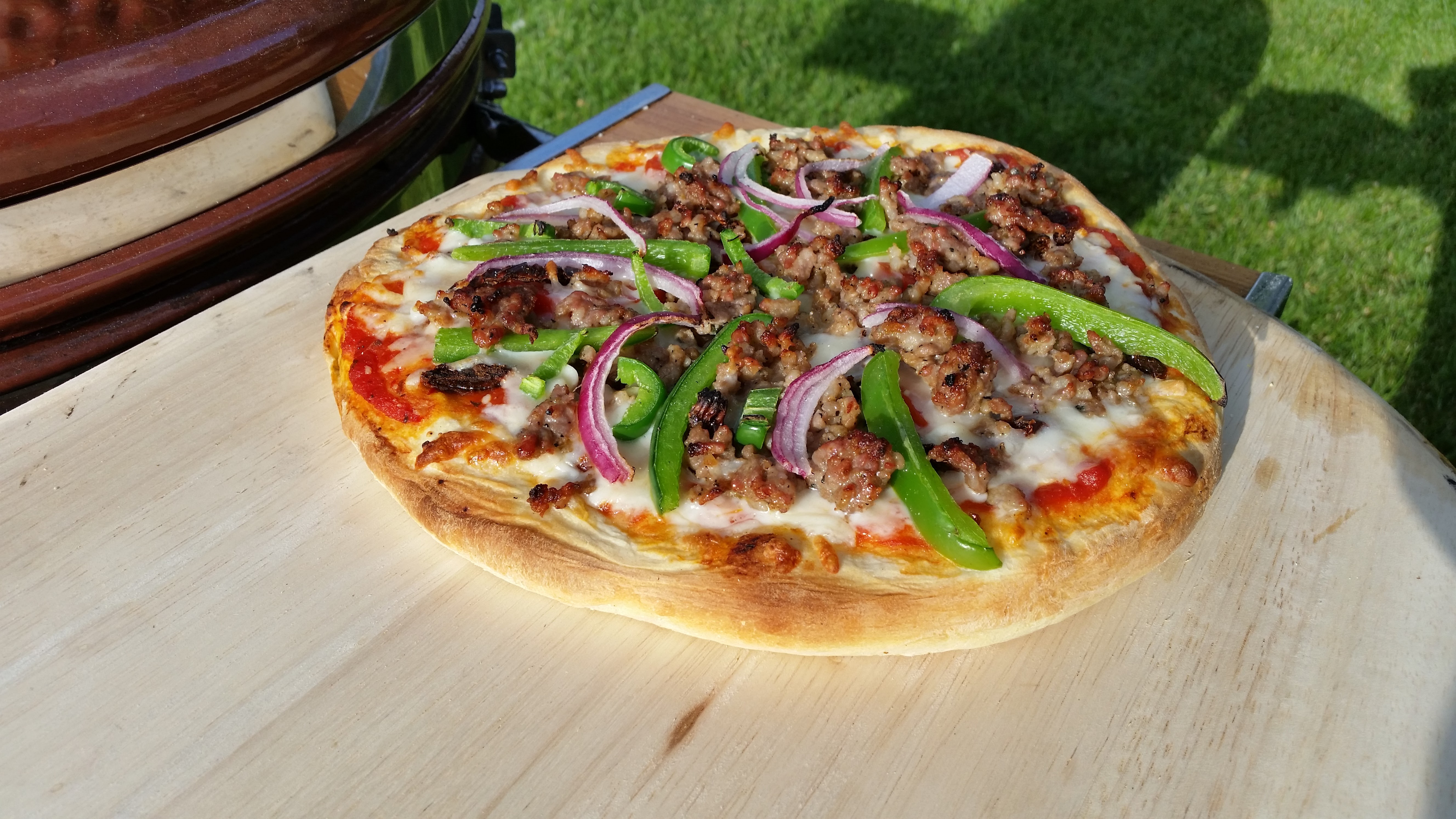 grilled homemade pizza with ground beef green pepper and onions