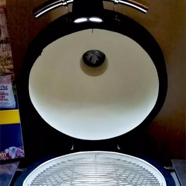 The GL-320 Maverick grill light is shown on a Saffire grill with the lid open and the light shining down into the grill
