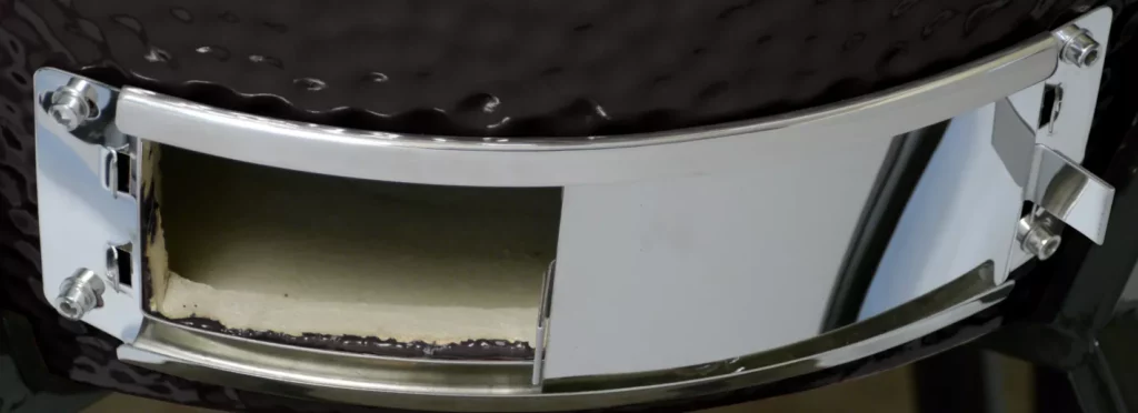 The grill's ash vent is fully open, with the ash guard open as well.