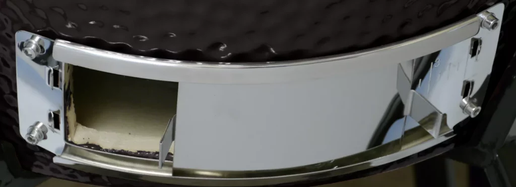 The grill's ash vent is mostly open, with the ash guard open as well.