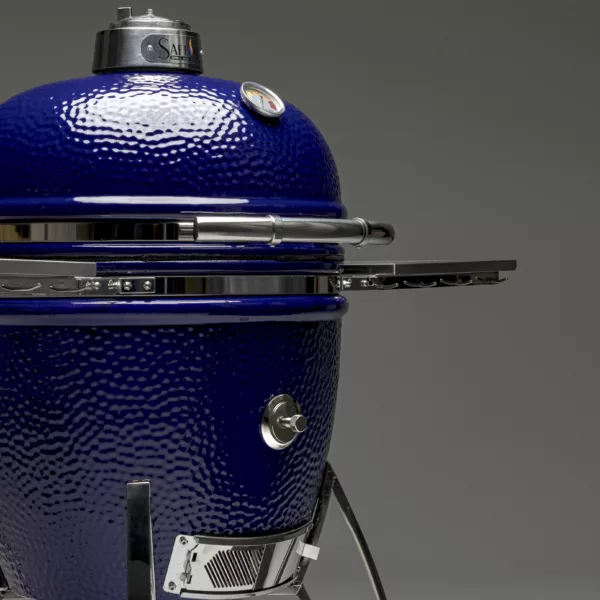A glamor shot of a blue Saffire charcoal grill