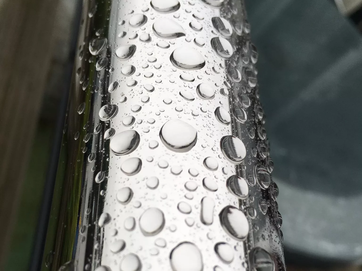 Close up image of water droplets on a stainless steel pipe