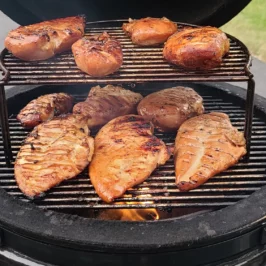 Ten chicken breasts of various sizes are cooking on a Medium Saffire kamado,