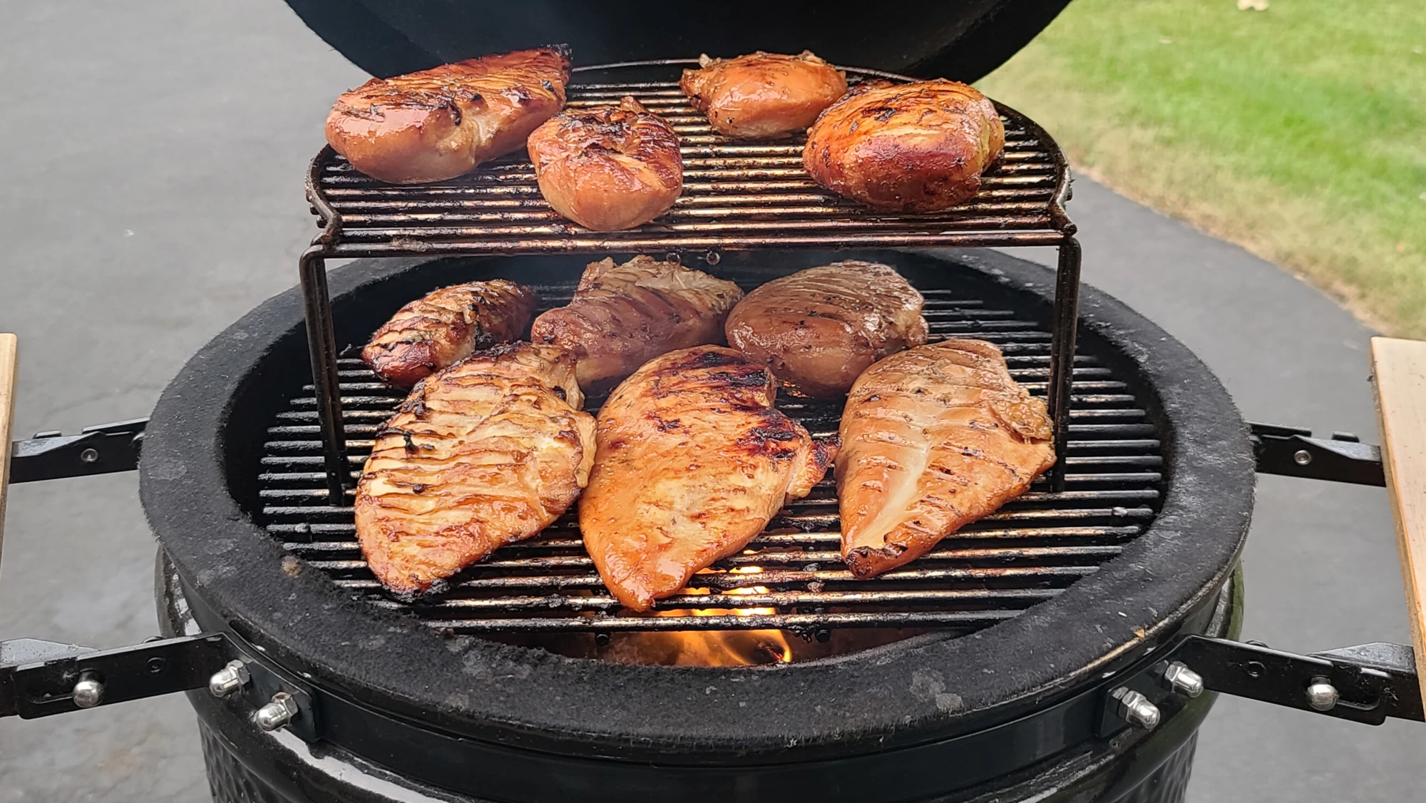 Ten chicken breasts of various sizes are cooking on a Medium Saffire kamado, six on the Primary Cooking Grid, and four on the elevated Secondary Cooking Grid above.