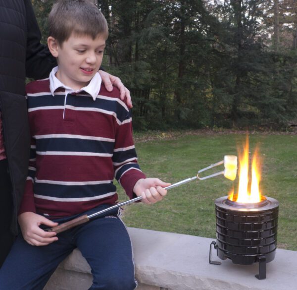 a young lad roasting mashmellow on a saffire grill