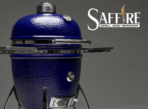 The Saffire ceramic kamado grill stands at an angle, with the beautiful blue enameled glaze glistening in the light.