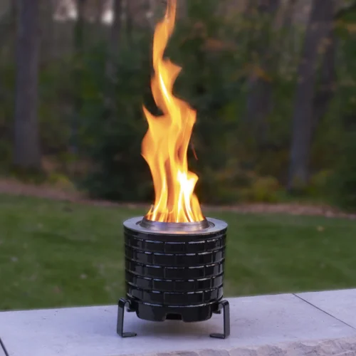 Saffire Tabletop Charcoal Fire Pit, outdoors with a large flame.