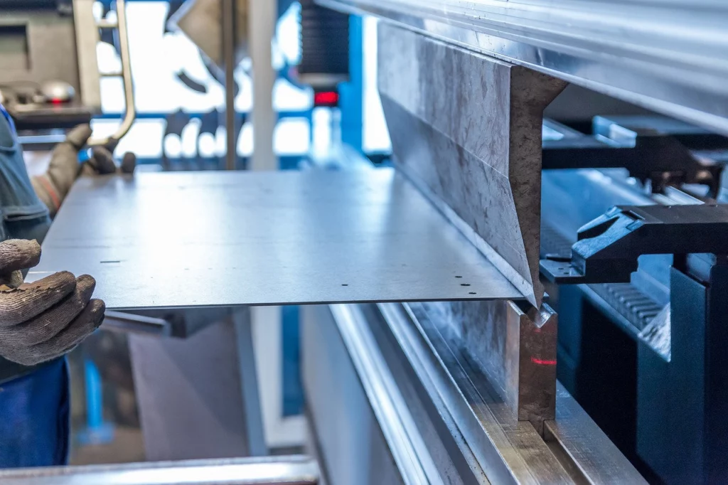 A worker bending sheet metal.