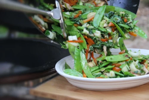 Stir-fry with green bean crisps, chives, celery, red peppers, and broccoli