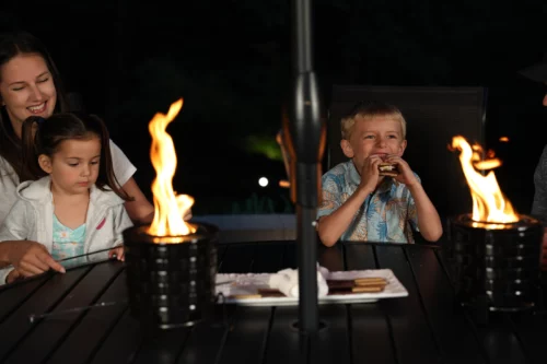 a boy sitting at a table with a man and a woman